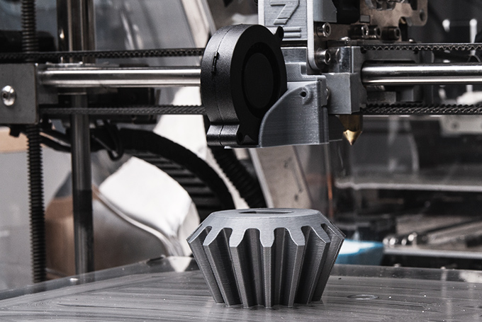 A 3d printer making a large gear-shaped object.